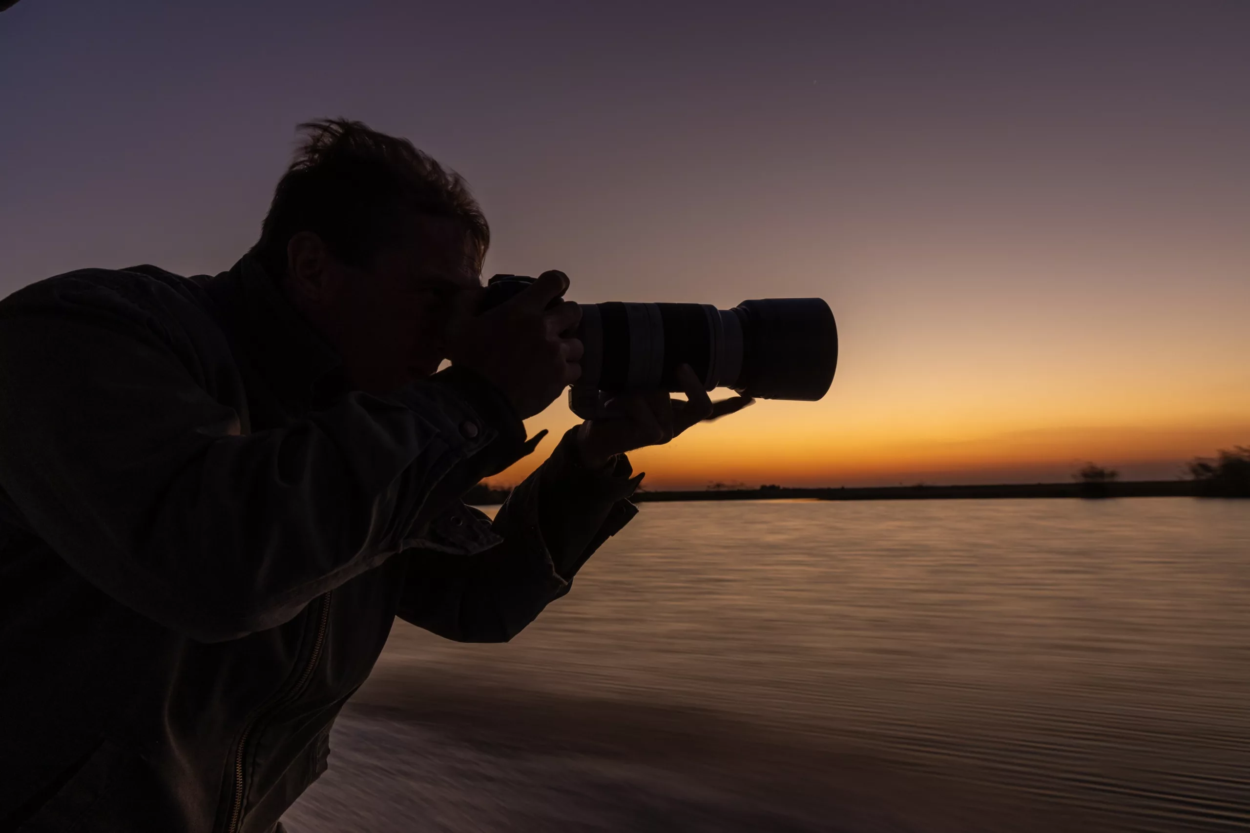 Guest with camera gear on safari in Botswana pangolin photo safaris