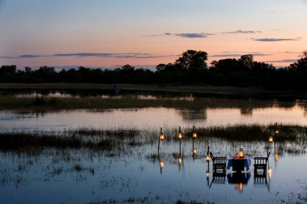Outdoor dining experience at Okavango Explorers Camp.