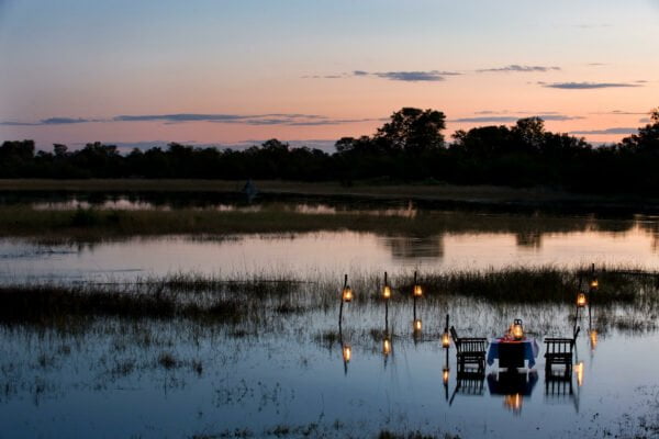 Great plains Selinda Pioneer Botswana camp river dining Outdoor dining experience at Okavango Explorers Camp.