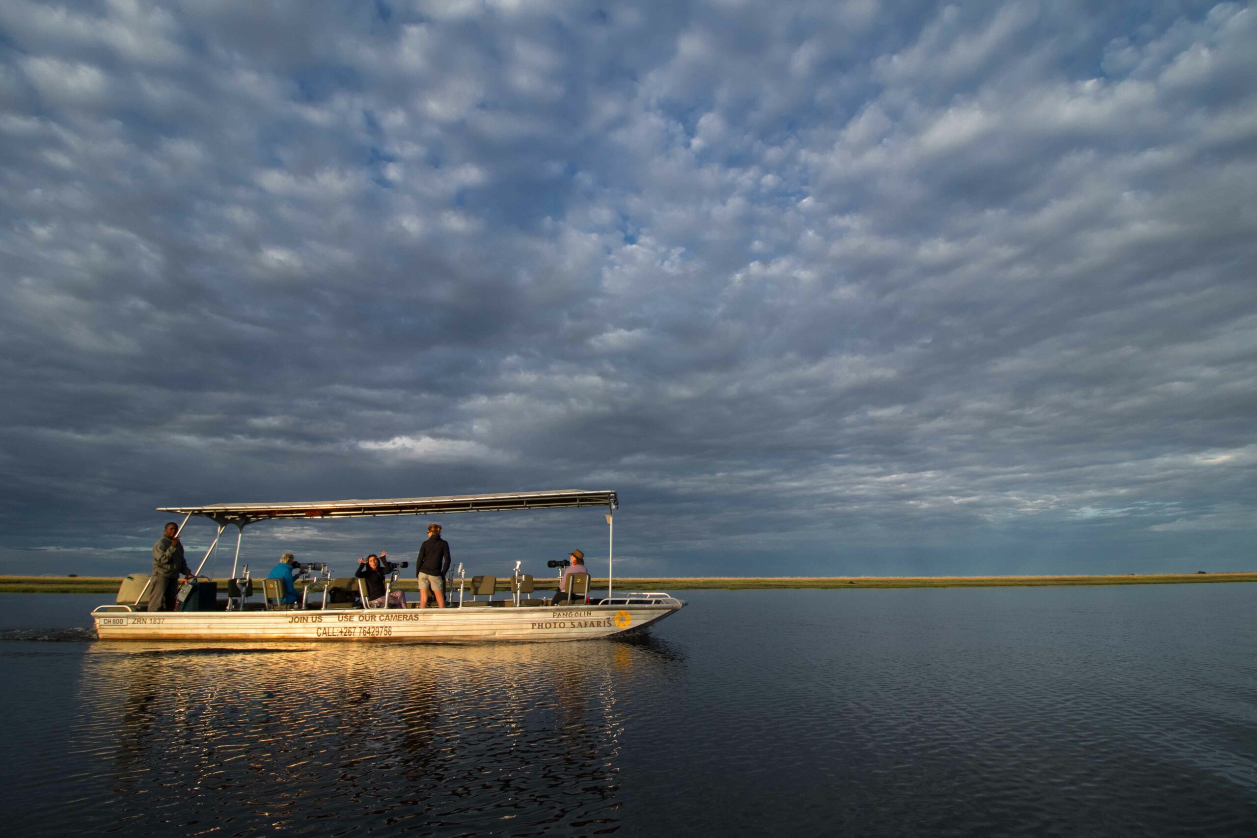 the photo boat on the still waters of the chobe